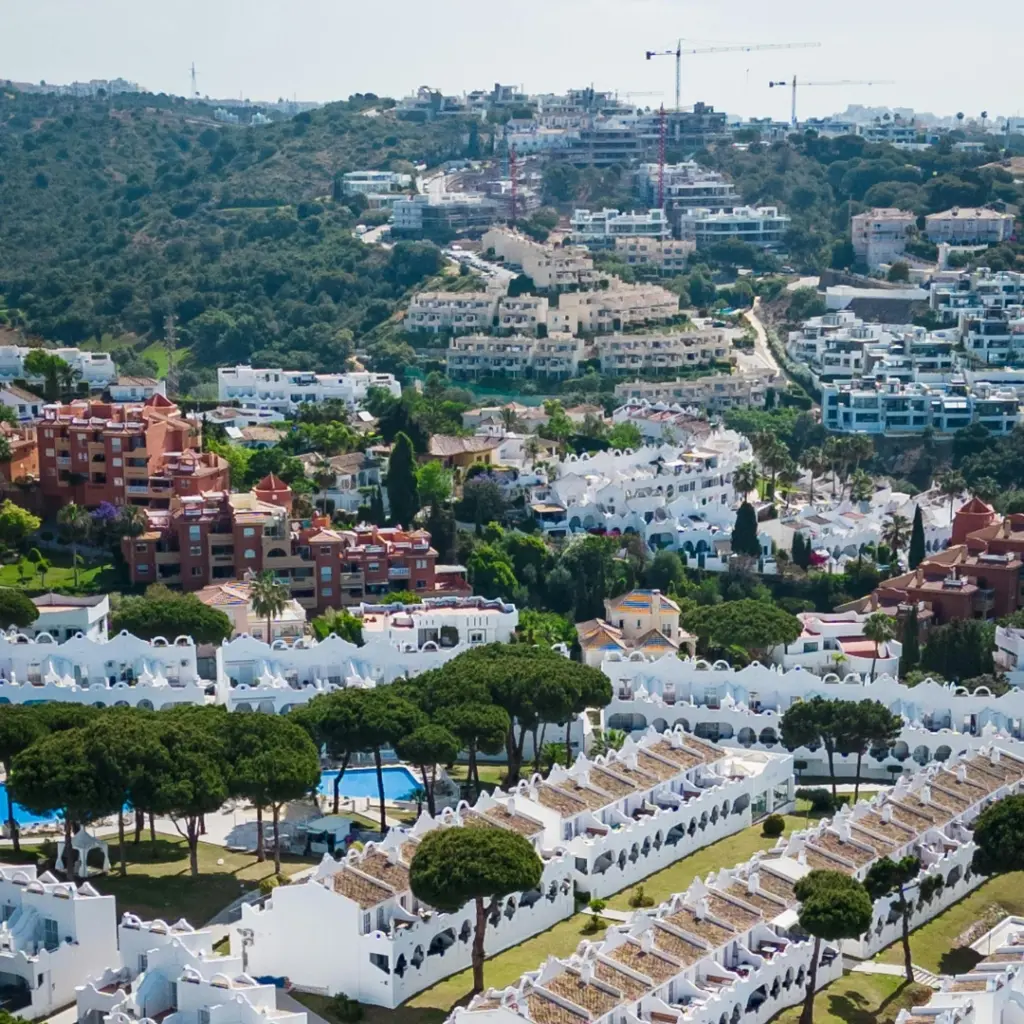 Aerial view of a luxury Mediterranean resort complex in Marbella, managed by Golden Partners in collaboration with Kristina Szekely International Realty.